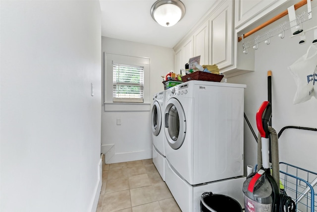 4701 Avenue N 1/2 Ave N 1/2, Galveston, TX 77551 - laundry area featuring cabinet space, washing machine and clothes dryer, and light tile patterned flooring