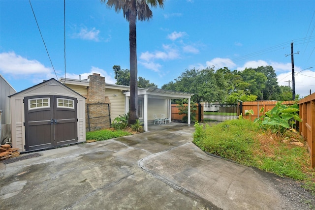 4701 Avenue N 1/2 Ave N 1/2, Galveston, TX 77551 - ranch-style house featuring a storage shed, a patio area, a carport, a chimney, and concrete driveway