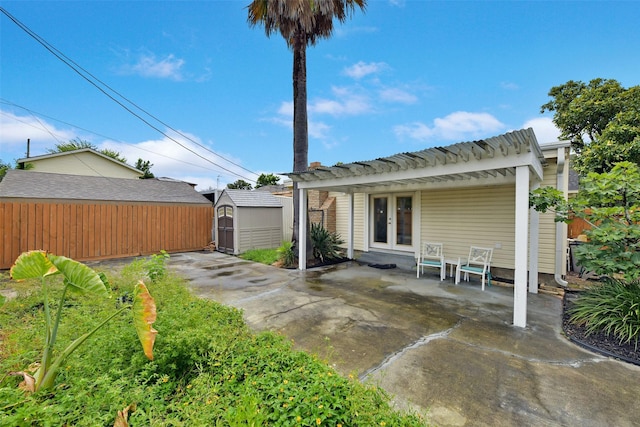 4701 Avenue N 1/2 Ave N 1/2, Galveston, TX 77551 - rear view of property with a storage unit, french doors, a patio area, and a pergola