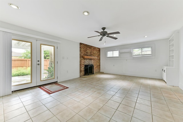 4701 Avenue N 1/2 Ave N 1/2, Galveston, TX 77551 - unfurnished living room featuring a wall mounted AC, ceiling fan, light tile patterned floors, french doors, and a brick fireplace