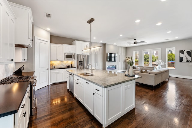 1822 Mcilhenny St Unit A, Houston, TX 77004 - kitchen with stainless steel appliances, backsplash, a ceiling fan, dark wood-style flooring, and recessed lighting