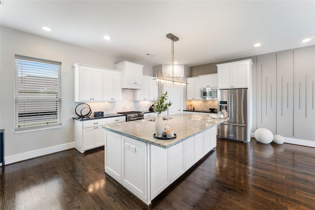 1822 Mcilhenny St Unit A, Houston, TX 77004 - kitchen featuring high quality appliances, white cabinetry, decorative backsplash, and recessed lighting