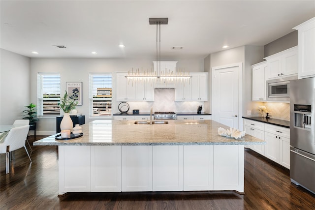 1822 Mcilhenny St Unit A, Houston, TX 77004 - kitchen with appliances with stainless steel finishes, backsplash, a spacious island, white cabinets, and recessed lighting