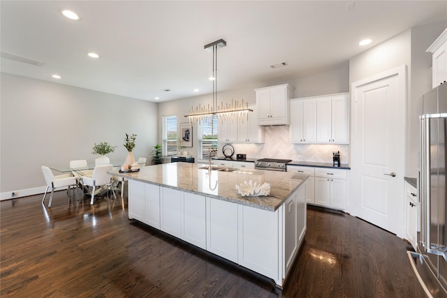 1822 Mcilhenny St Unit A, Houston, TX 77004 - kitchen with white cabinets, dark wood-type flooring, an island with sink, tasteful backsplash, and recessed lighting