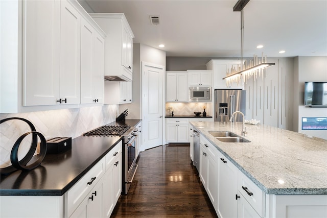 1822 Mcilhenny St Unit A, Houston, TX 77004 - kitchen featuring high end appliances, a spacious island, recessed lighting, white cabinets, and decorative backsplash