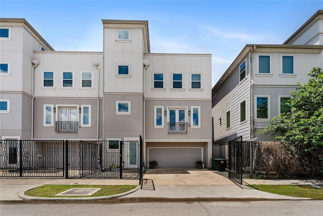 1822 Mcilhenny St Unit A, Houston, TX 77004 - view of front of property featuring stucco siding, concrete driveway, and a garage
