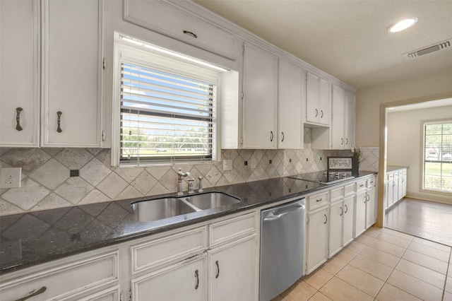 18120 County Road 127, Pearland, TX 77581 - kitchen with dishwasher, white cabinetry, black electric cooktop, light tile patterned floors, and backsplash