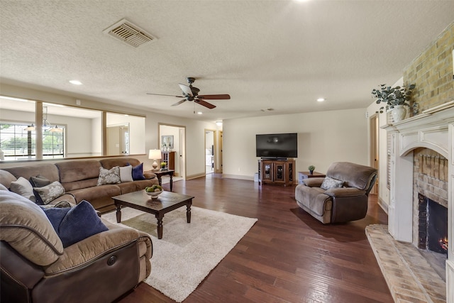 18120 County Road 127, Pearland, TX 77581 - living room with a fireplace, dark wood-style floors, a textured ceiling, ceiling fan, and recessed lighting