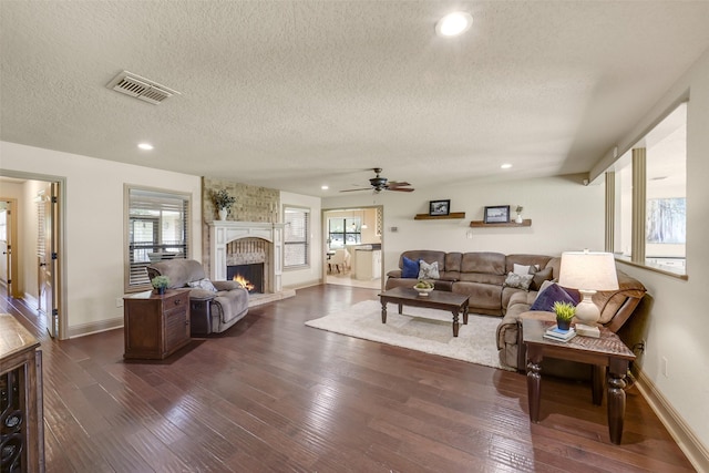 18120 County Road 127, Pearland, TX 77581 - living area featuring a textured ceiling, dark wood-style floors, plenty of natural light, a brick fireplace, and recessed lighting