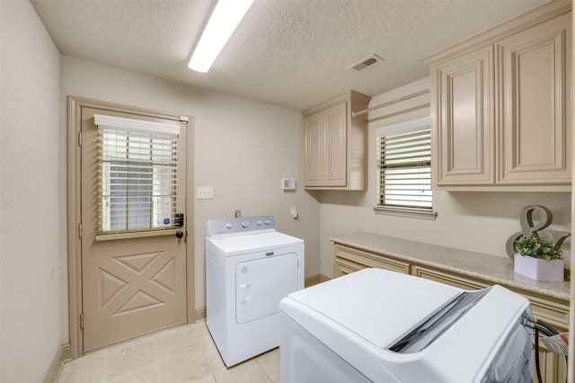 18120 County Road 127, Pearland, TX 77581 - laundry area with independent washer and dryer, cabinet space, light tile patterned flooring, and a textured ceiling