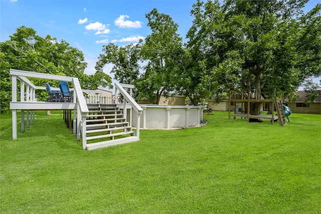 18120 County Road 127, Pearland, TX 77581 - view of grassy yard featuring an outdoor pool, stairway, and a wooden deck