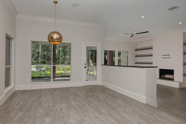 25 Red Sable Pt, The Woodlands, TX 77380 - unfurnished living room featuring crown molding, ceiling fan, wood finished floors, a fireplace, and recessed lighting