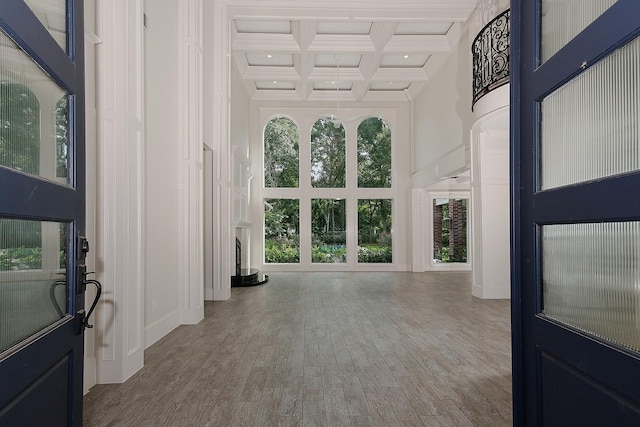 25 Red Sable Pt, The Woodlands, TX 77380 - unfurnished living room featuring a high ceiling, beam ceiling, coffered ceiling, wood finished floors, and recessed lighting