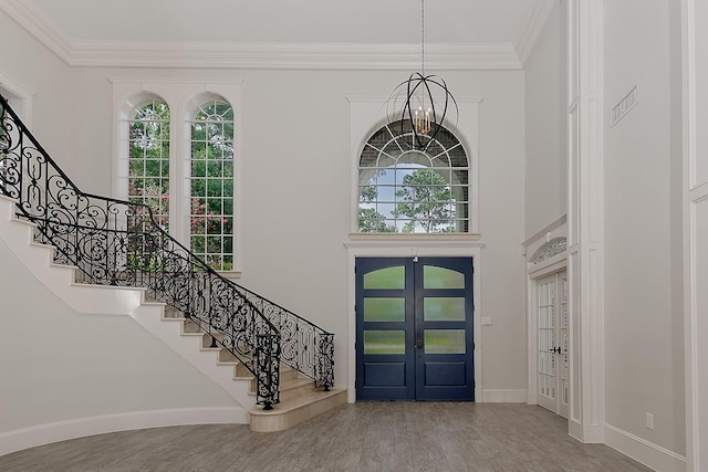 25 Red Sable Pt, The Woodlands, TX 77380 - entryway with french doors, stairway, wood finished floors, ornamental molding, and a chandelier