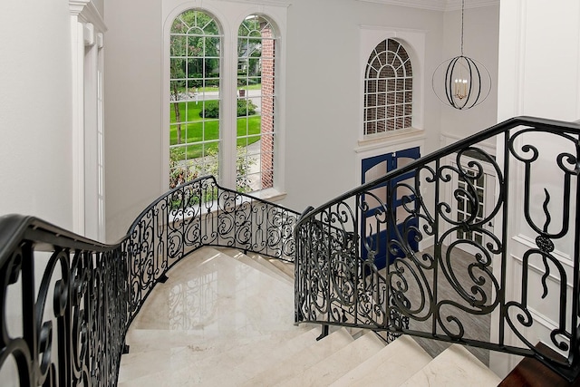25 Red Sable Pt, The Woodlands, TX 77380 - stairs featuring a chandelier, ornamental molding, and plenty of natural light