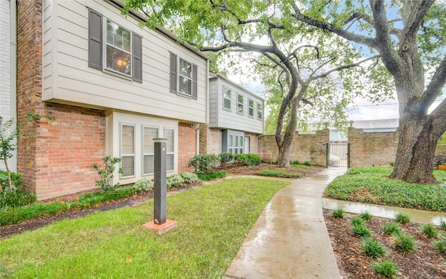 14123 Misty Meadow Ln, Houston, TX 77079 - view of front of property with brick siding, a gate, and a front yard