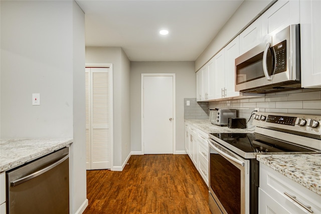 14123 Misty Meadow Ln, Houston, TX 77079 - kitchen with appliances with stainless steel finishes, backsplash, white cabinetry, dark wood-style floors, and light stone counters