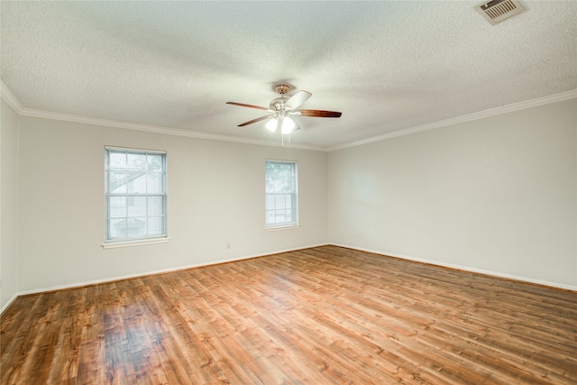 14123 Misty Meadow Ln, Houston, TX 77079 - spare room featuring plenty of natural light, wood finished floors, ceiling fan, a textured ceiling, and crown molding