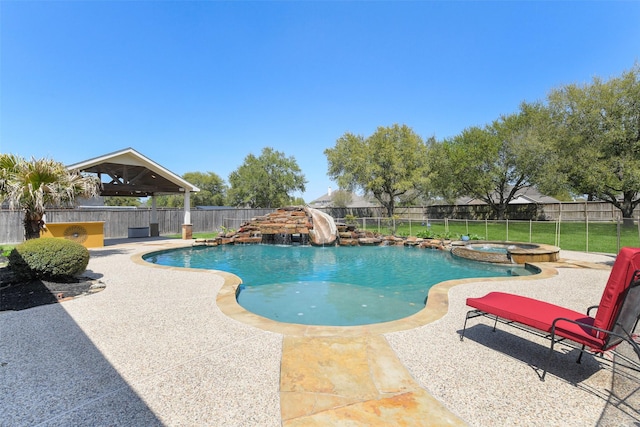 17310 Calico Peak Way, Cypress, TX 77433 - view of swimming pool featuring a patio, a fenced backyard, a water slide, and a pool with connected hot tub