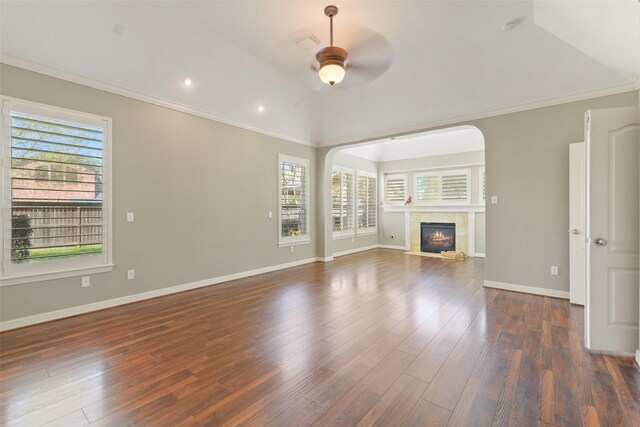 17310 Calico Peak Way, Cypress, TX 77433 - unfurnished living room featuring a ceiling fan, dark wood-type flooring, vaulted ceiling, a fireplace, and ornamental molding