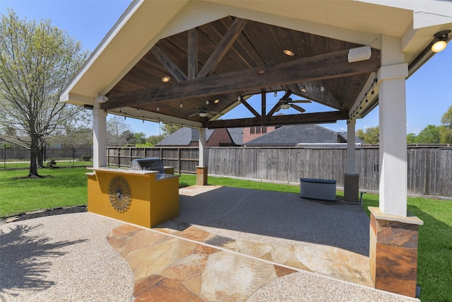 17310 Calico Peak Way, Cypress, TX 77433 - fenced backyard featuring a gazebo, a ceiling fan, a patio, and an outdoor kitchen