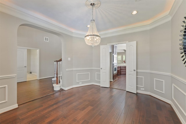 17310 Calico Peak Way, Cypress, TX 77433 - unfurnished dining area with arched walkways, dark wood-style flooring, ornamental molding, a chandelier, and stairway