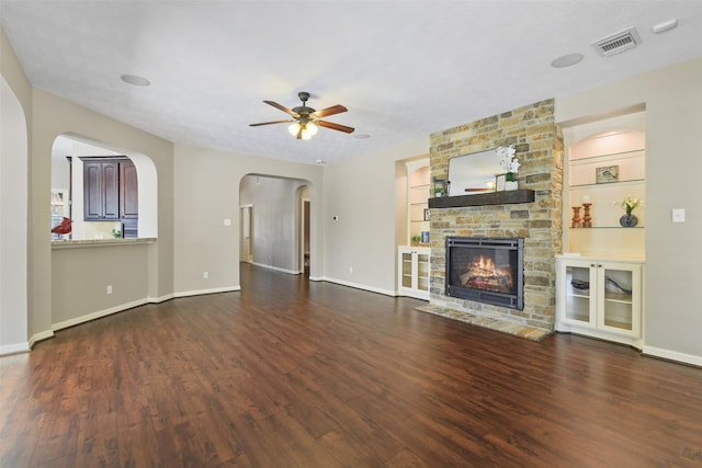 17310 Calico Peak Way, Cypress, TX 77433 - unfurnished living room with wood finished floors, ceiling fan, a stone fireplace, and built in shelves