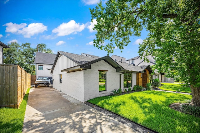 5122 Glenmeadow Dr, Houston, TX 77096 - view of front facade featuring brick siding, roof with shingles, and board and batten siding