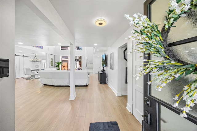5122 Glenmeadow Dr, Houston, TX 77096 - entryway featuring light wood finished floors, a barn door, and recessed lighting