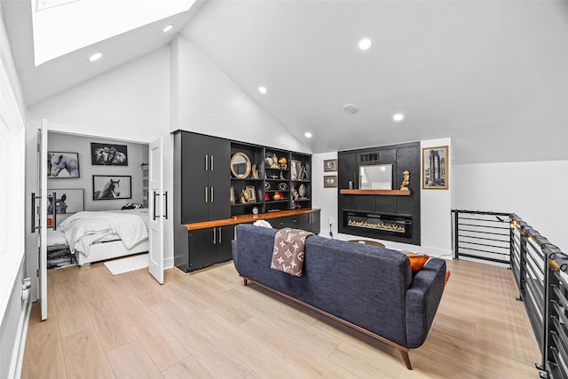 5122 Glenmeadow Dr, Houston, TX 77096 - living room featuring a skylight, recessed lighting, light wood-style floors, high vaulted ceiling, and a fireplace
