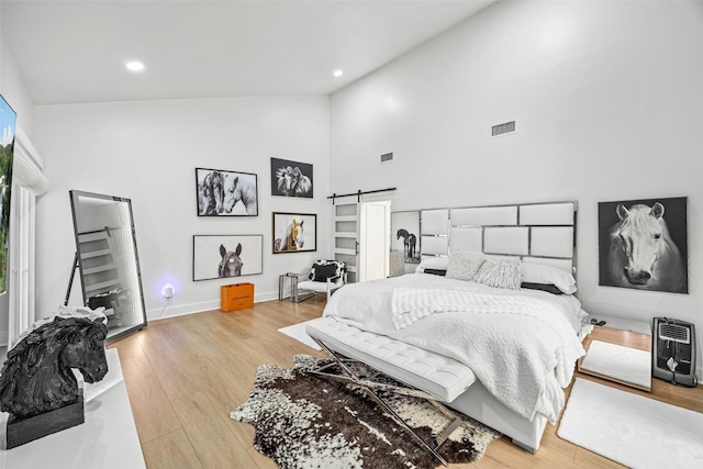 5122 Glenmeadow Dr, Houston, TX 77096 - bedroom with high vaulted ceiling, light wood-style flooring, heating unit, and recessed lighting