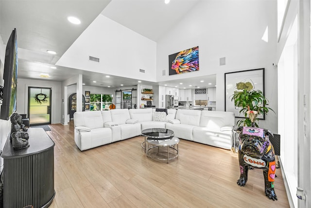 5122 Glenmeadow Dr, Houston, TX 77096 - living area with high vaulted ceiling, light wood-style flooring, and recessed lighting