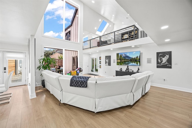 5122 Glenmeadow Dr, Houston, TX 77096 - living room featuring a high ceiling, light wood-style floors, and recessed lighting