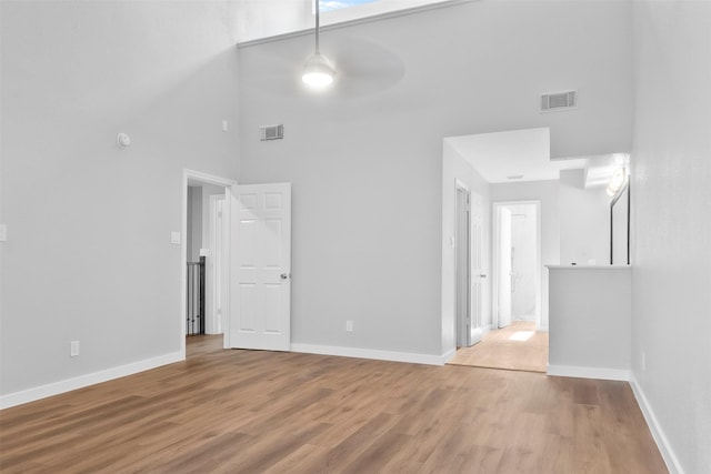 668 N Eldridge Pkwy, Houston, TX 77079 - spare room with a high ceiling, wood finished floors, and ceiling fan