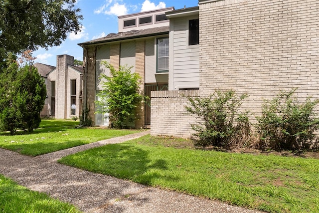 668 N Eldridge Pkwy, Houston, TX 77079 - view of home's exterior featuring a lawn and brick siding