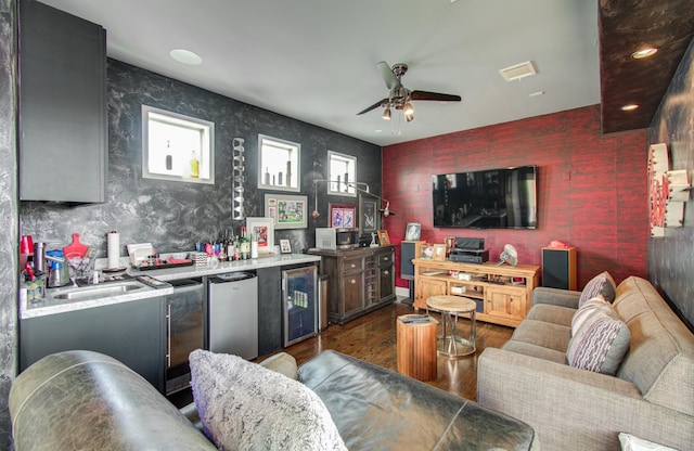 427 Tuam St Unit B, Houston, TX 77006 - living room with wine cooler, wet bar, wood finished floors, ceiling fan, and wallpapered walls