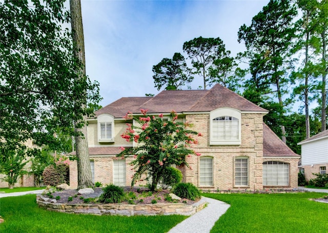 5307 Boyce Springs Dr, Houston, TX 77066 - french country inspired facade with a front yard, brick siding, and roof with shingles