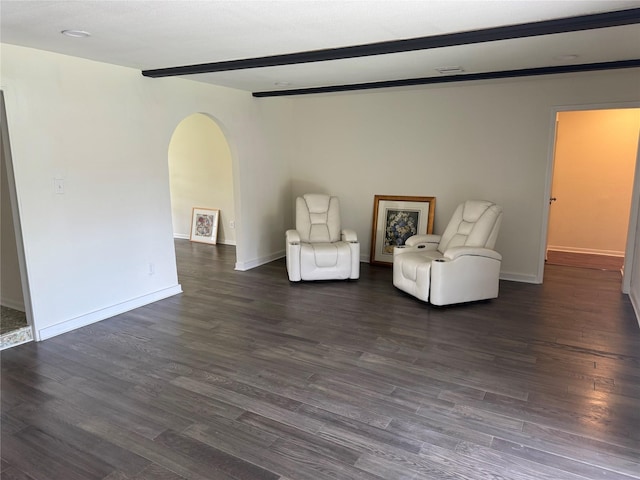 8446 Cabot St, Houston, TX 77078 - living area featuring arched walkways, dark wood-style flooring, and beamed ceiling