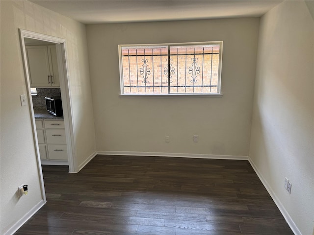 8446 Cabot St, Houston, TX 77078 - unfurnished room featuring dark wood-style flooring and baseboards