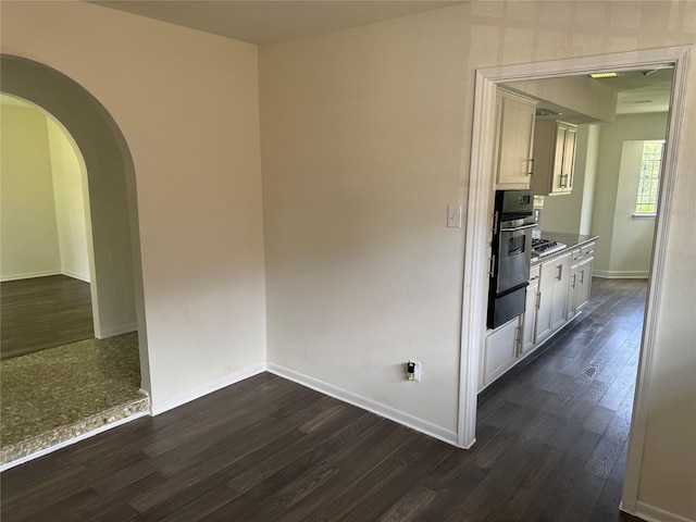 8446 Cabot St, Houston, TX 77078 - empty room with dark wood finished floors and arched walkways