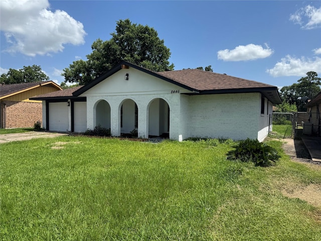 8446 Cabot St, Houston, TX 77078 - view of front of house featuring a shingled roof, brick siding, a garage, and a gate