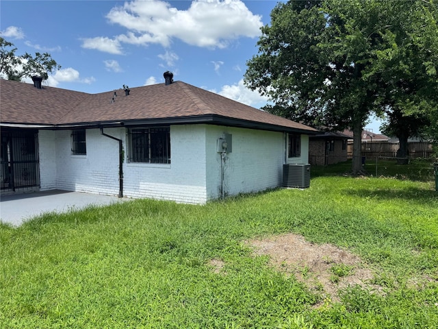 8446 Cabot St, Houston, TX 77078 - view of side of home with a shingled roof and brick siding