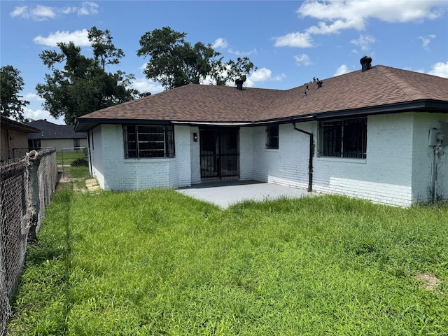 8446 Cabot St, Houston, TX 77078 - rear view of house featuring brick siding, roof with shingles, and a patio