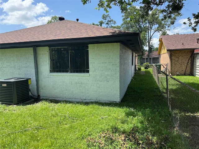 8446 Cabot St, Houston, TX 77078 - view of side of home with brick siding and a shingled roof
