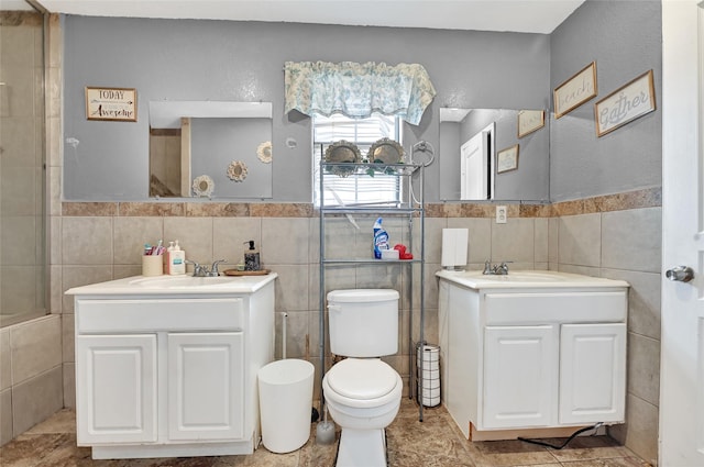 1802 Kowis St, Houston, TX 77093 - full bathroom with tile walls, two vanities, wainscoting, and tile patterned floors