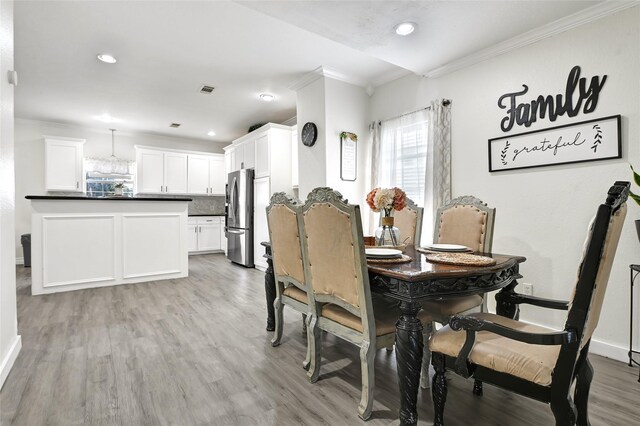 1802 Kowis St, Houston, TX 77093 - dining area with ornamental molding, light wood-style floors, and recessed lighting
