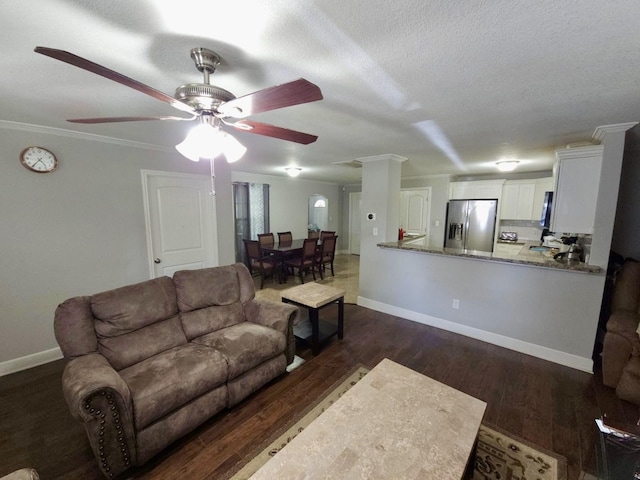 6227 Cavalier St Unit 770, Houston, TX 77087 - living room featuring dark wood-style flooring, a ceiling fan, and a textured ceiling