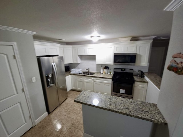 6227 Cavalier St Unit 770, Houston, TX 77087 - kitchen featuring stainless steel appliances, white cabinetry, tasteful backsplash, light stone countertops, and crown molding