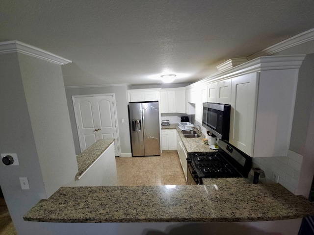 6227 Cavalier St Unit 770, Houston, TX 77087 - kitchen featuring stainless steel appliances, light stone countertops, crown molding, white cabinets, and a peninsula