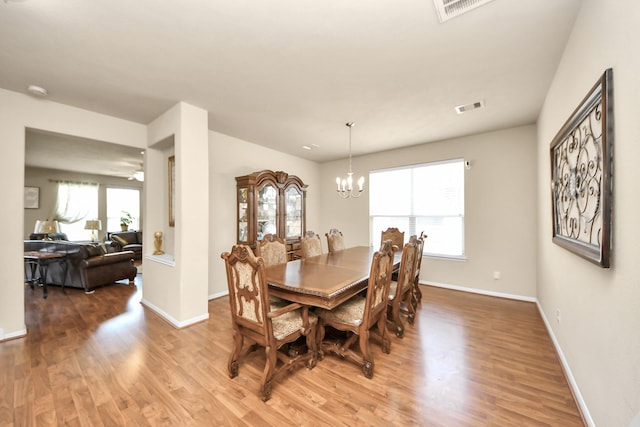 3811 Rosalind Ln, Houston, TX 77053 - dining area with light wood-type flooring, healthy amount of natural light, and a chandelier